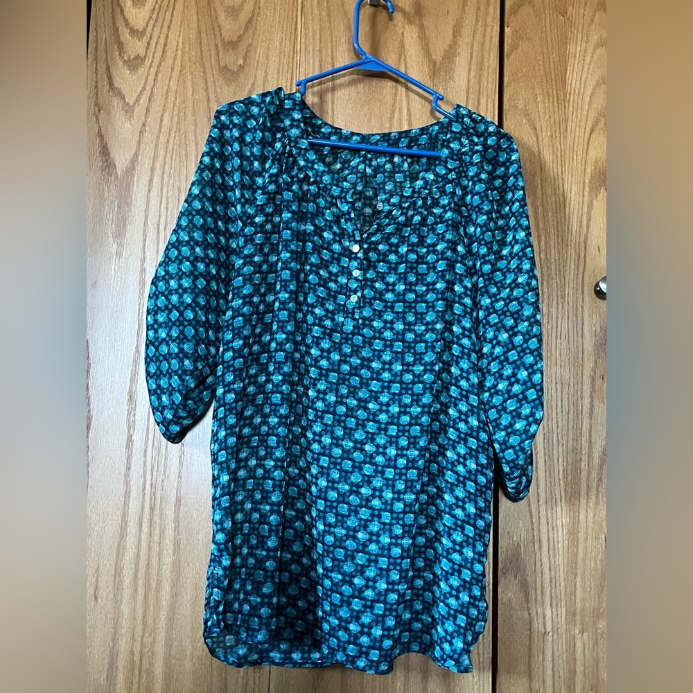 Blue green sheer blouse with pulled up sleeves